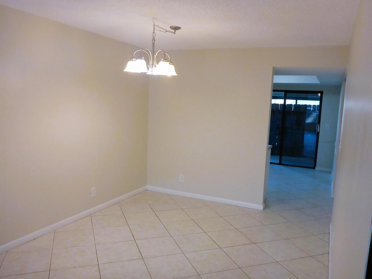 431 Jupiter Lakes Boulevard, Unit 2109A Jupiter, FL 33458 - Photo 6 of 23 a view of an empty room with a chandelier fan