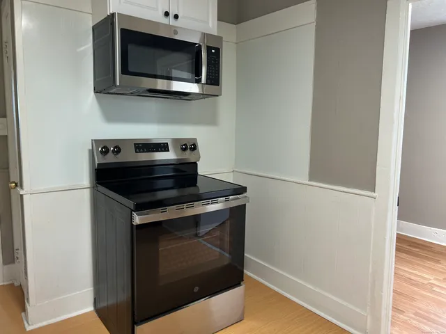 a stove top oven sitting inside of a kitchen