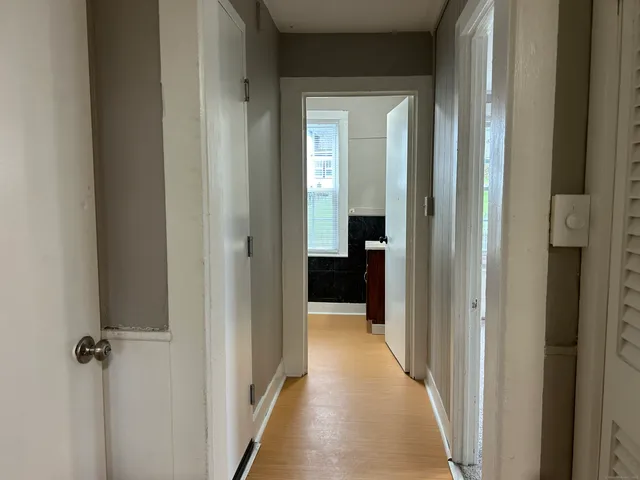 a view of a hallway with a wooden door