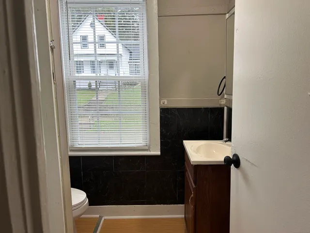 a bathroom with a sink a toilet and a shower