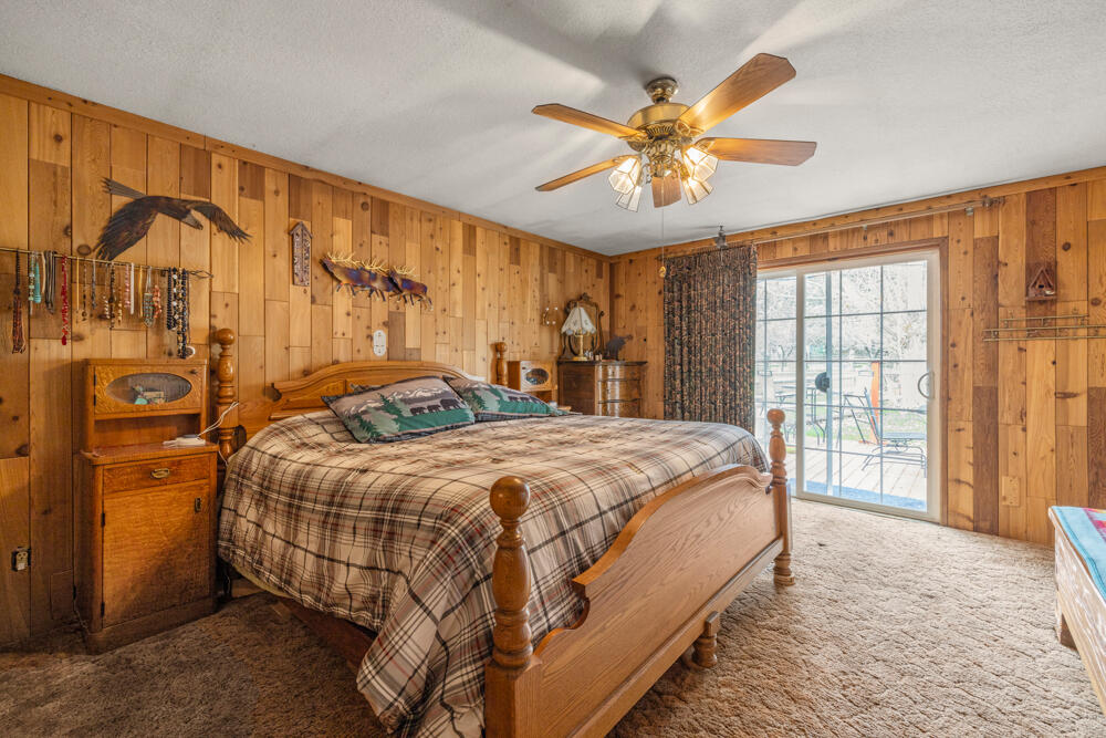 47477 Gerber Road Bonanza, OR 97623 - Photo 51 of 63 a bedroom with a large bed and a chandelier