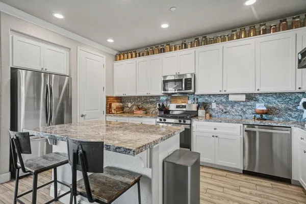 a kitchen with kitchen island granite countertop a sink and counter space