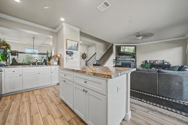 a kitchen with stainless steel appliances granite countertop a refrigerator and a stove top oven