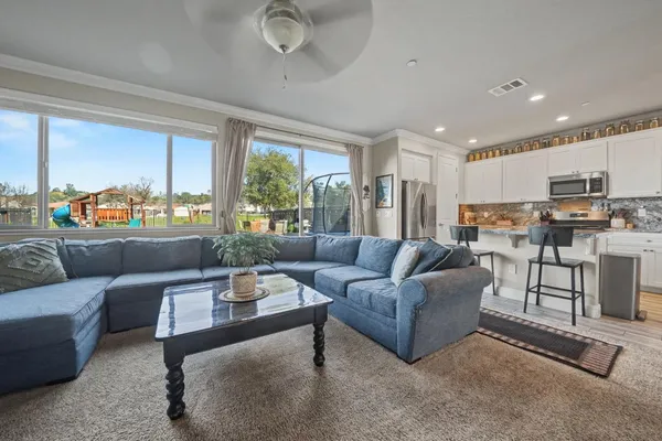 a bedroom with a bed lamp and paintings on the wall