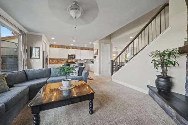 a spacious bedroom with a bed and a chandelier