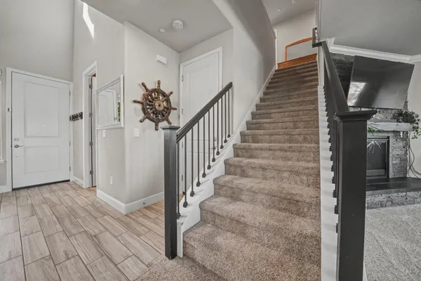 a bedroom with a large bed and a flat tv screen on dresser