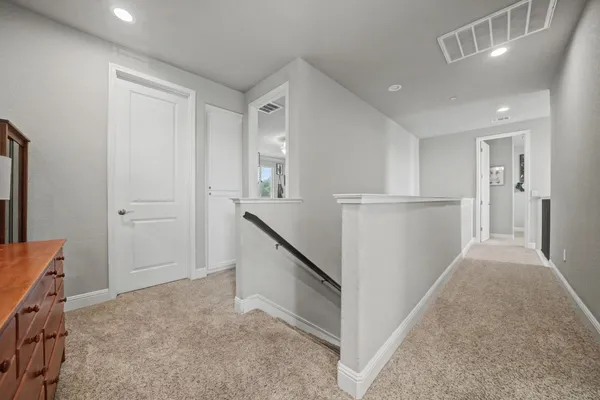 a bathroom with a tub a double vanity sink and a window