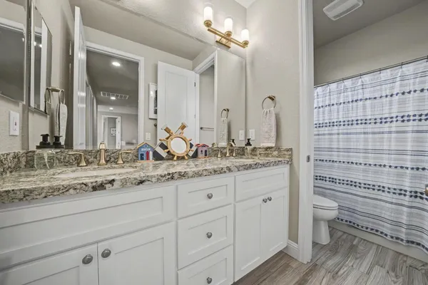 a view of a house with backyard water fountain and sitting area