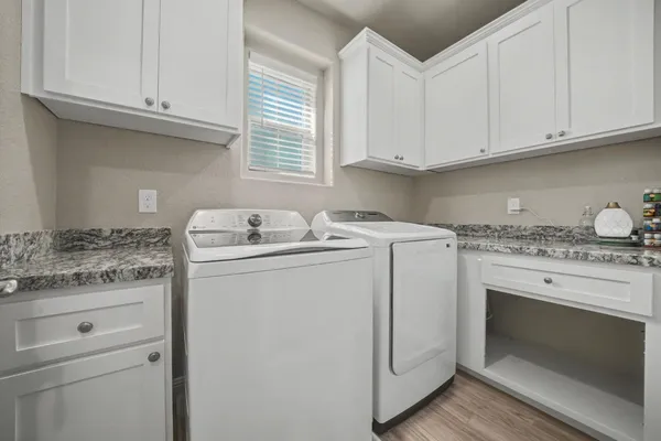 an aerial view of residential houses with outdoor space and parking
