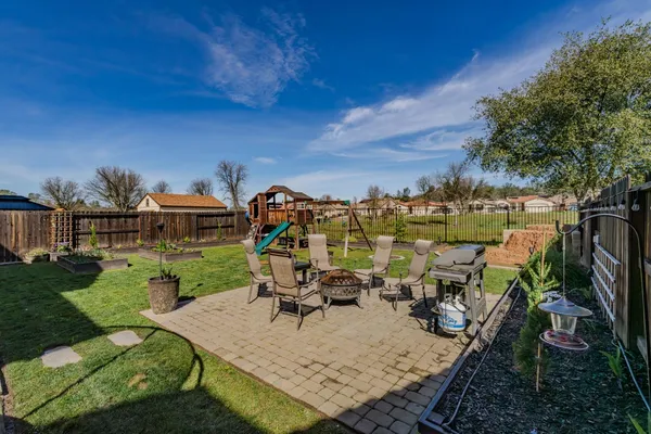 a view of a house with backyard and sitting area