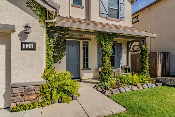 a view of a house with potted plants