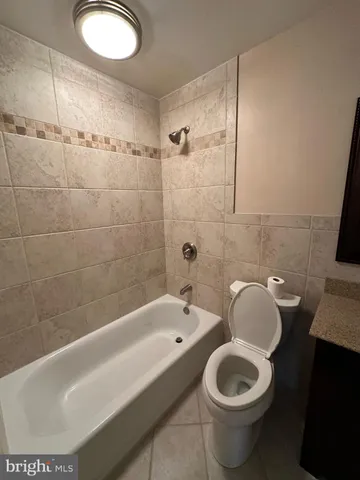 a bathroom with a toilet and a bathtub