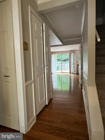 a view of hallway with wooden floor