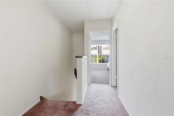 a view of a hallway with a wooden floor