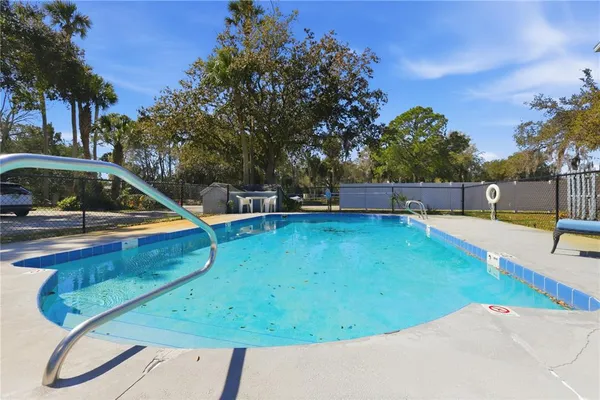 a view of a backyard with swimming pool