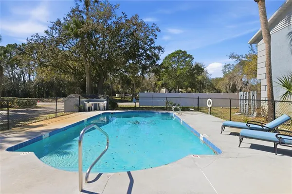 a view of a swimming pool with a lounge chair