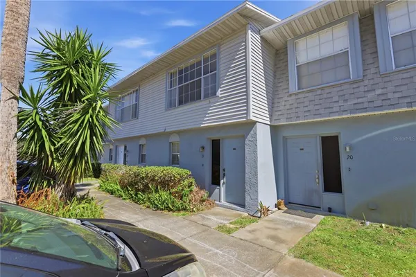 a house with a yard and potted plants