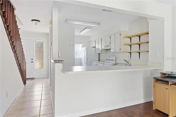 a kitchen with stainless steel appliances a refrigerator sink and cabinets
