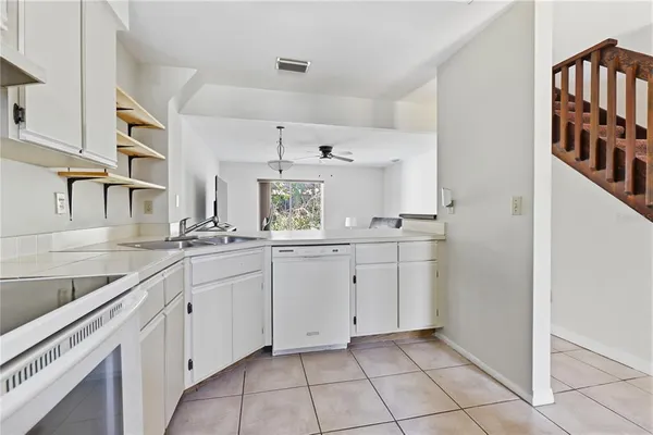 a kitchen with cabinets and window