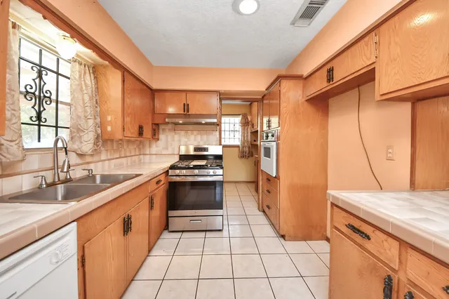 a kitchen with a sink stove and refrigerator
