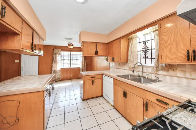 a kitchen with stainless steel appliances granite countertop a sink stove and cabinets
