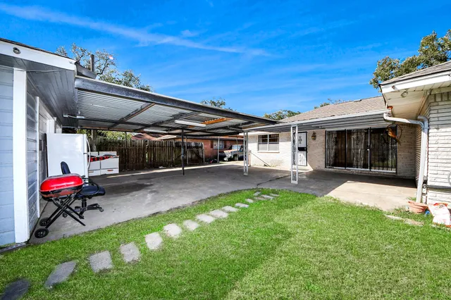 a view of yard with a table and chairs and floor to ceiling window