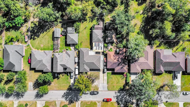 an aerial view of multiple houses with a yard