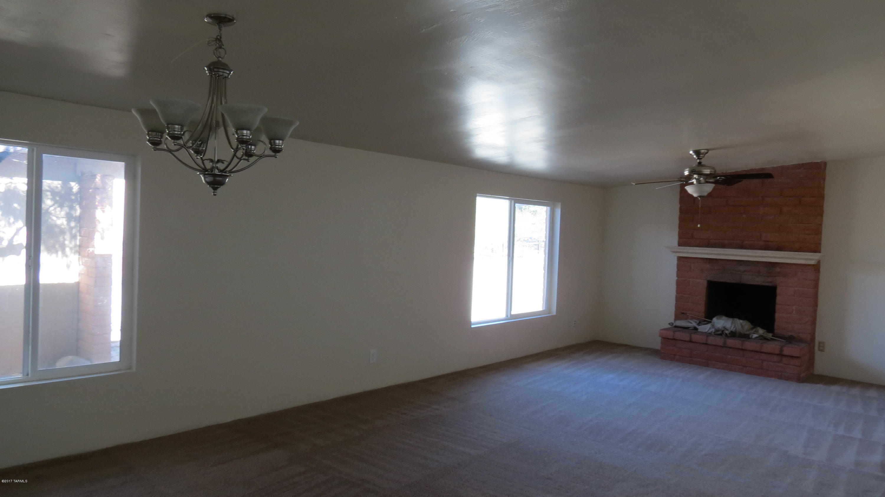 6601 North Mona Lisa Road Tucson, AZ 85741 - Photo 2 of 23 a view of a livingroom with a fireplace and window