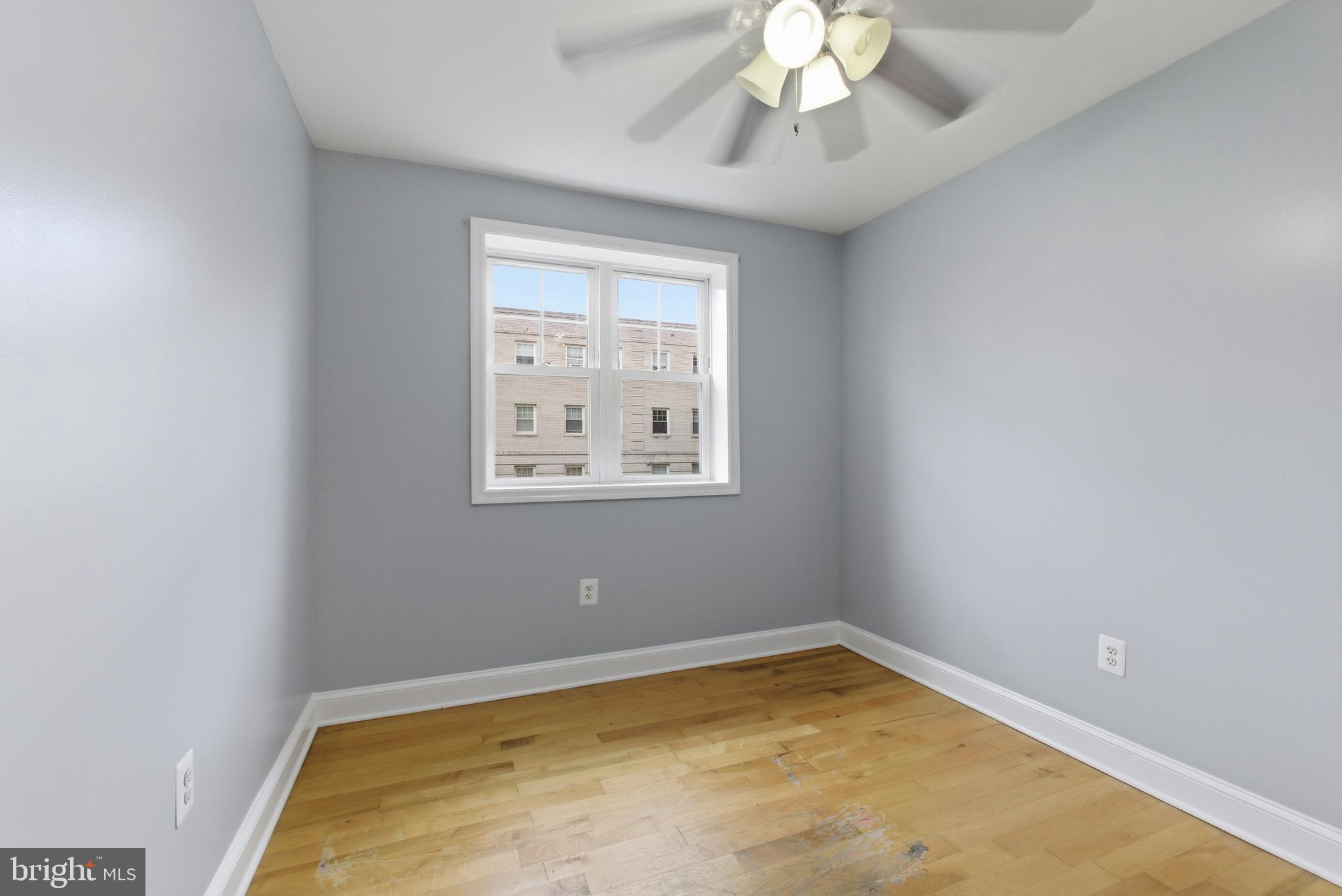 3872 9th Street Southeast, Unit 201 Washington, DC 20032 - Photo 8 of 17 an empty room with a chandelier fan and a window