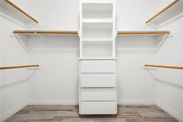 a view of walk in closet with empty racks
