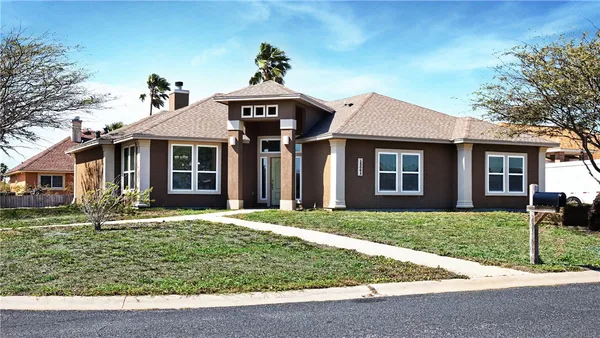 a front view of a house with a yard