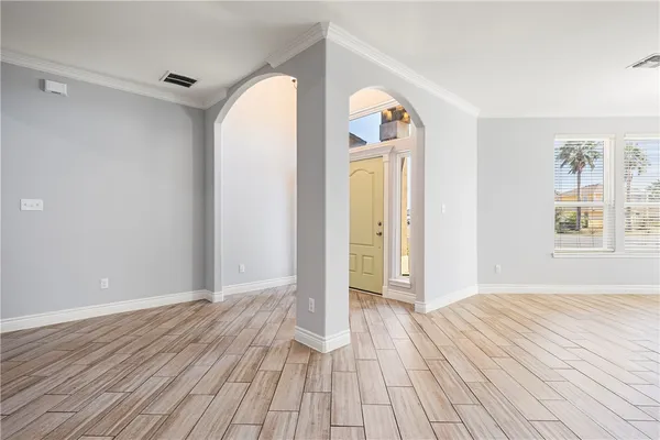 a view of a room with wooden floor and a bathroom