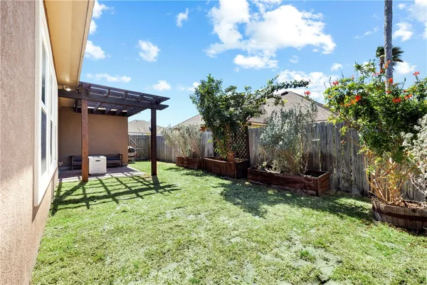 a view of chairs and bench in backyard