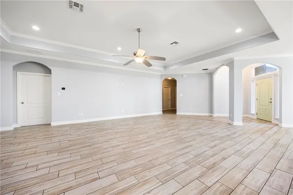 a view of empty room with wooden floor