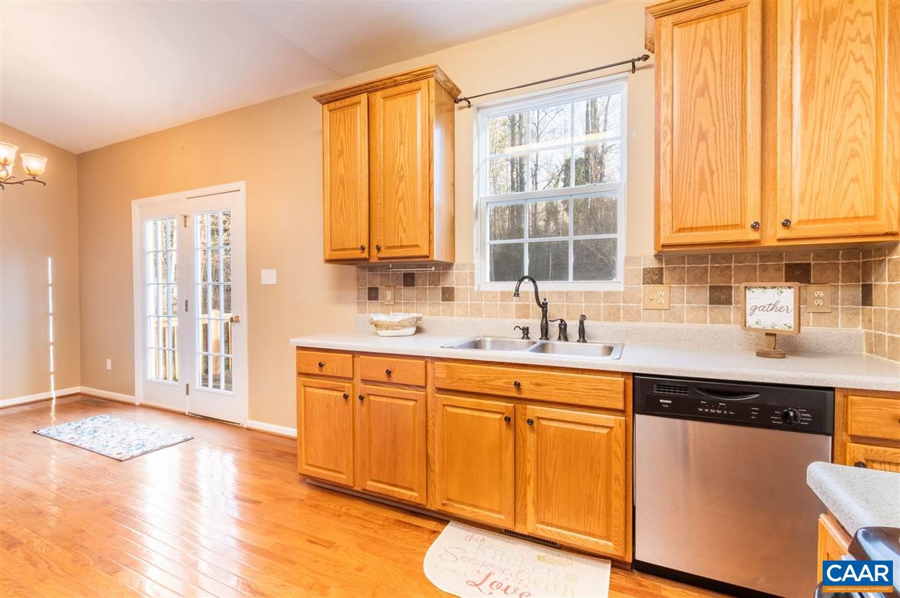 260 Geranium Road Ruckersville, VA 22968 - Photo 11 of 32 a kitchen with stainless steel appliances granite countertop a sink and a window