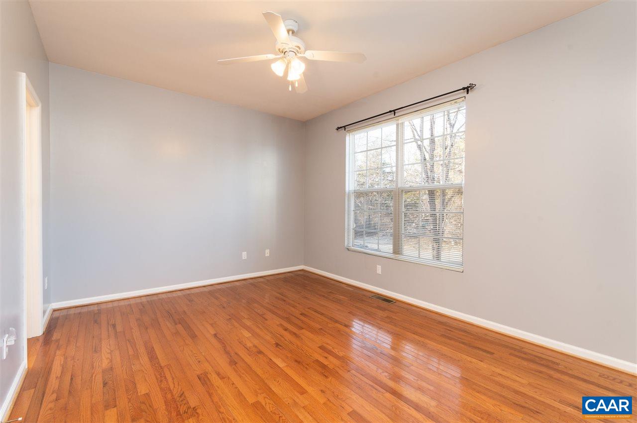 260 Geranium Road Ruckersville, VA 22968 - Photo 14 of 32 an empty room with wooden floor chandelier fan and windows