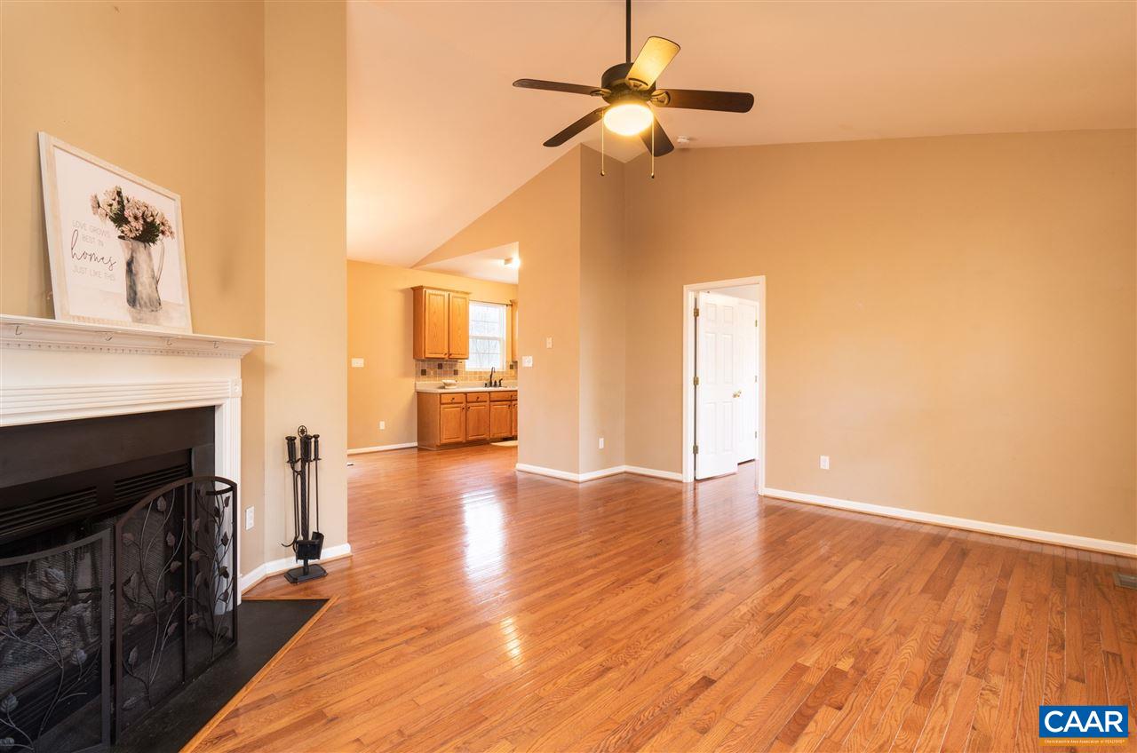 260 Geranium Road Ruckersville, VA 22968 - Photo 3 of 32 a view of a livingroom with wooden floor and a ceiling fan