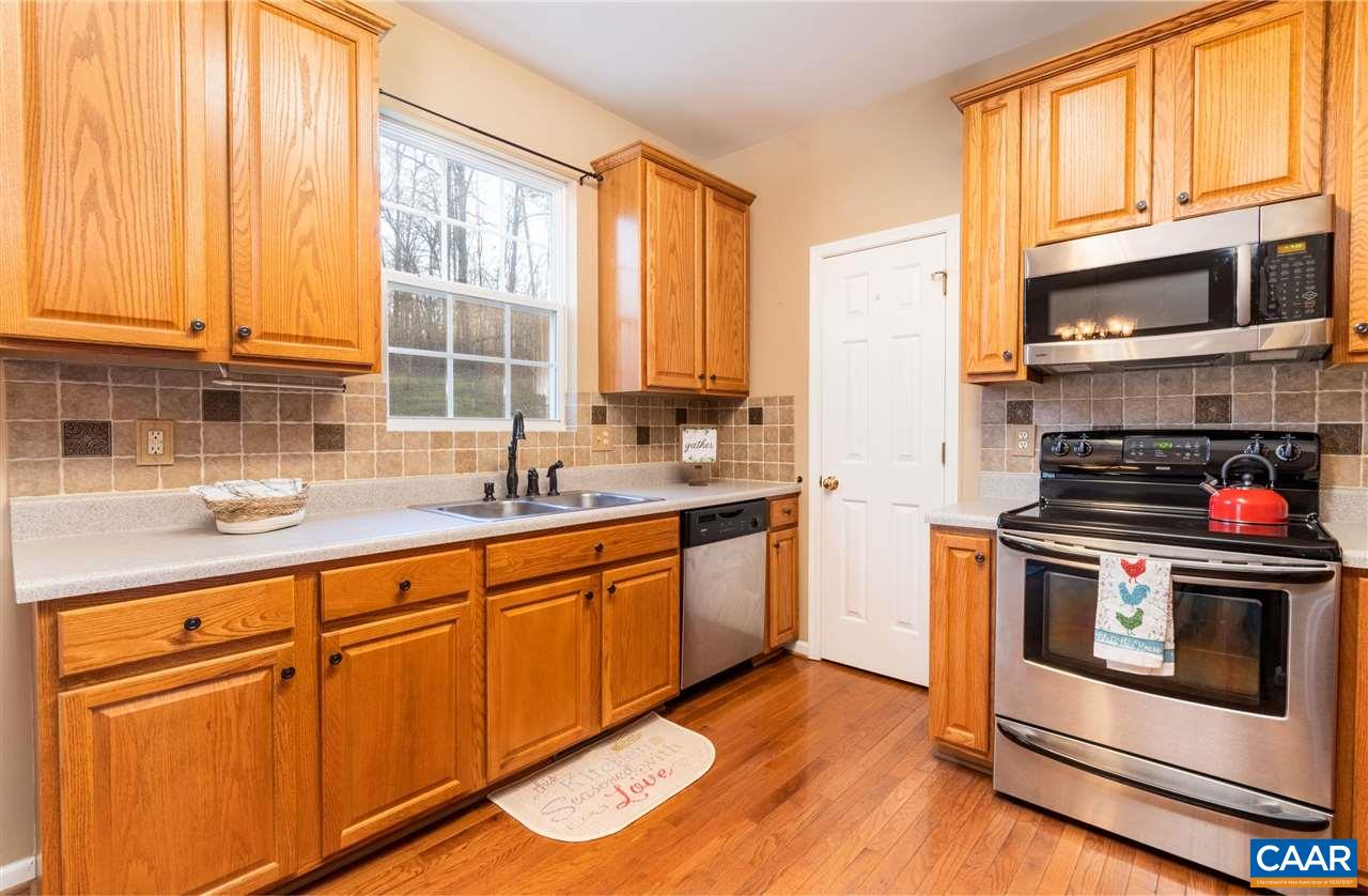 260 Geranium Road Ruckersville, VA 22968 - Photo 10 of 32 a kitchen with stainless steel appliances granite countertop a stove a sink and a microwave