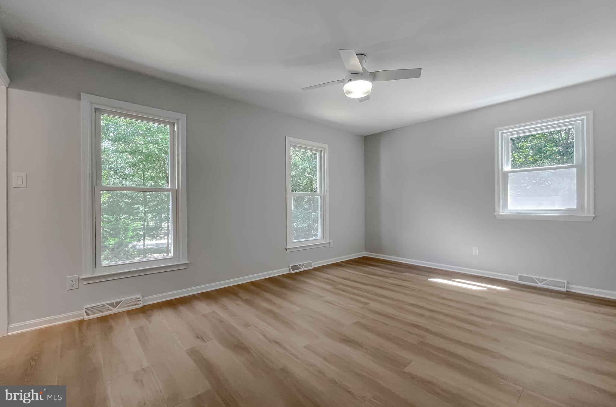 22373 Enoch Road Leonardtown, MD 20650 - Photo 38 of 74 a view of an empty room with wooden floor and a window