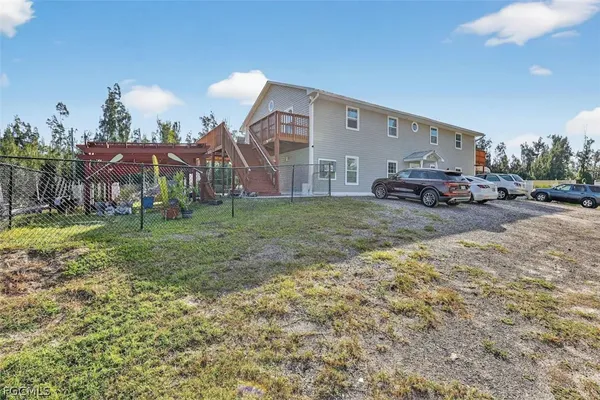 a view of a house with a yard and sitting area