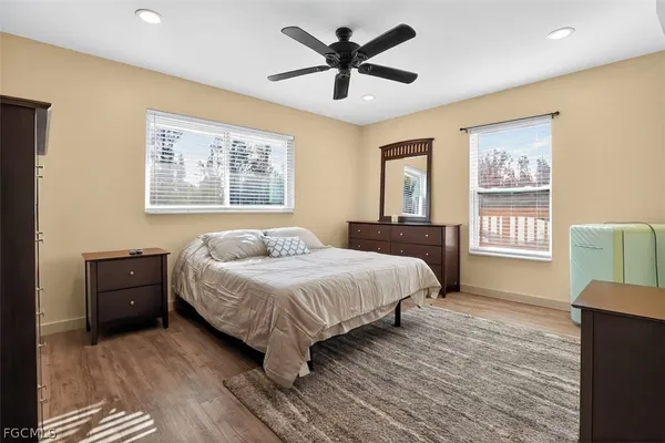 a spacious bedroom with a bed and a large window