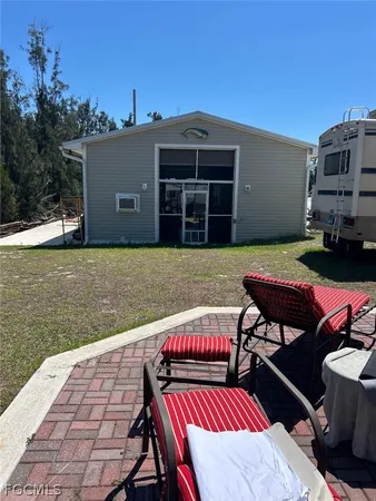 a view of a patio with table and chairs with wooden floor and fence