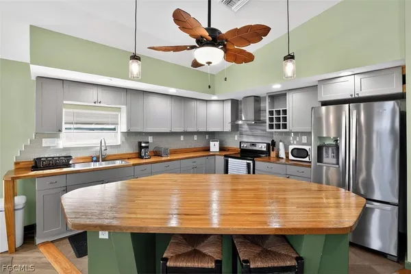 a large kitchen with a table and chairs