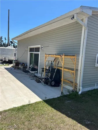 a view of a patio with table and chairs a barbeque and wooden fence
