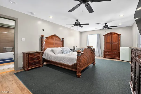 a bedroom with a bed and ceiling fan