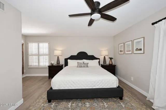 a bedroom with a bed and a large window