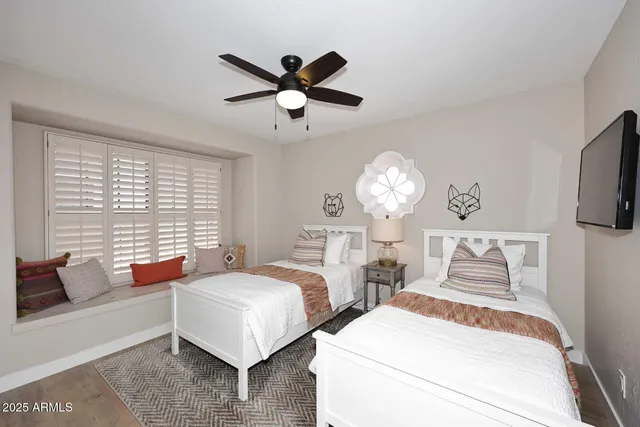 a bedroom with two beds and a chandelier