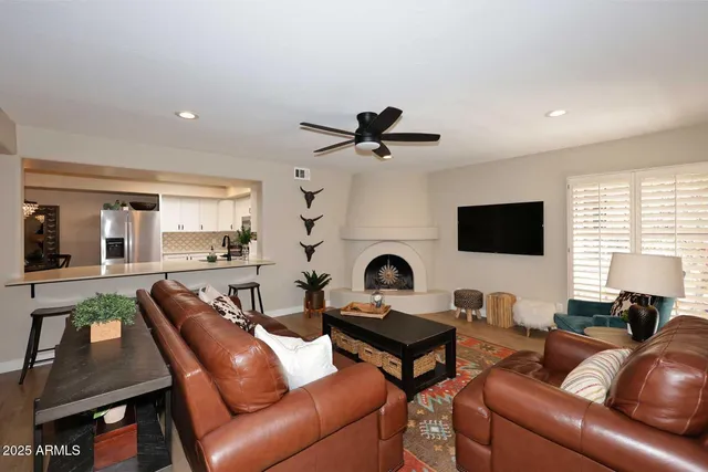 a living room with furniture a fireplace and a flat screen tv
