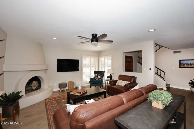 a living room with furniture a flat screen tv and a fireplace