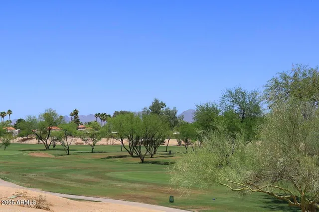 a view of a patio with a table and chairs under an umbrella